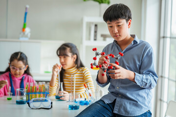 children boy using vr learning molecular structure in science laboratory
