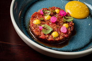beef tartare with sauce in restaurant