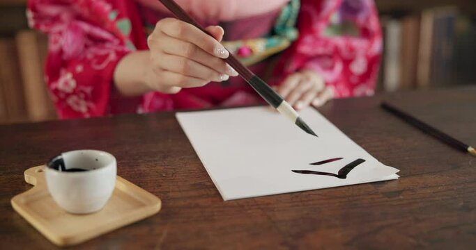 Paintbrush, ink and hands, Asian writing or script with paper, document and creativity, calligraphy and traditional text. Japanese font, writer with black paint and person at desk with art and tools