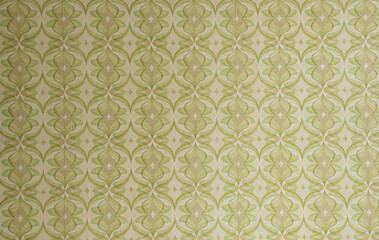 Old wallpaper on the wall. Old wallpaper for texture or background.