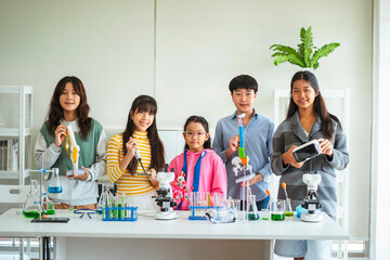 Group of children doing chemistry experiments for classroom learning