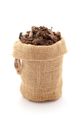 Close-up of Dry organic Sugandha Bala (Pavonia Odorata) roots, in a jute bag. Isolated over a white background.