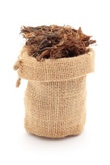Close-up of Dry organic Jatamansi (Nardostachys jatamansi) roots, in a jute bag. Isolated over a...