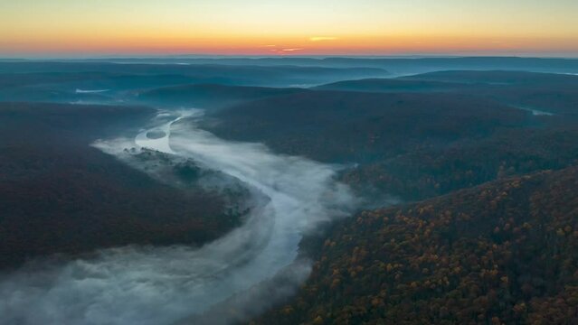 Aerial Hyperlapse over River in the forest at sunrise