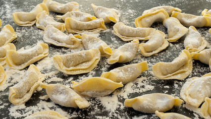 A kind of ravioli, casoncelli, home made traditional food of the Bergamo area, Italy. Delicious Italian food. Black background