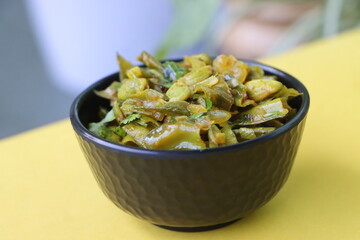 Masala flat green beans, onions, and curry spices, pan fried