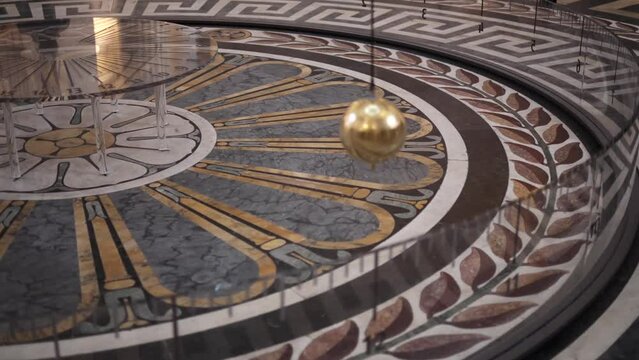 Foucault Pendulum in Paris Pantheon landmark building. Pendulum showing the Earth moving around its axis.