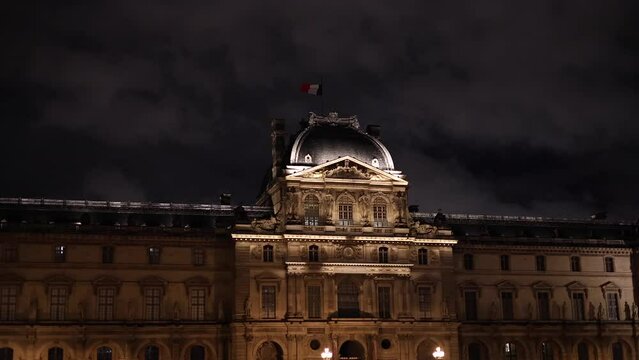 Louvre by night. 4K video with this landmark modern architecture building from Paris during the evening view to the pyramid and facade details.