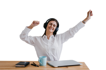 Cheerful hispanic young woman in shirt, headphones sitting at the table with closed laptop, having break, listening music stretching eyes closed against transparent background.