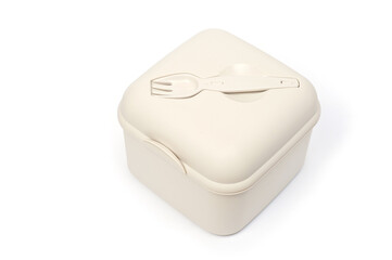 Plastic food container with built-in fork and gravy boat.