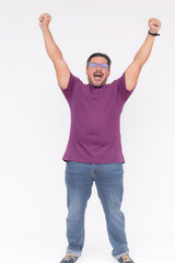 A man, feeling exhilarated, throwing his hands in the air. Celebrating victory, overwhelmed with...