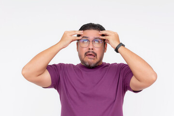 A middle aged man going crazy, rolling his eyes up, going loco. Isolated on a white background.