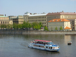 View of the boat, river and city on a spring day. Prague. Czech republic.