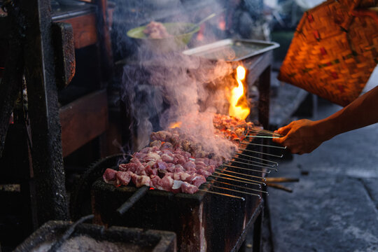 Sate Klatak grilling on charcoal is a unique street food of goat satay or mutton satay dish, originally from Bantul DIY Yogyakarta, Indonesia. Food, traditional, unique culinary concept