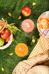 Advertising scene with picnic holiday concept. Top view of basket of organic fruits decorated with...