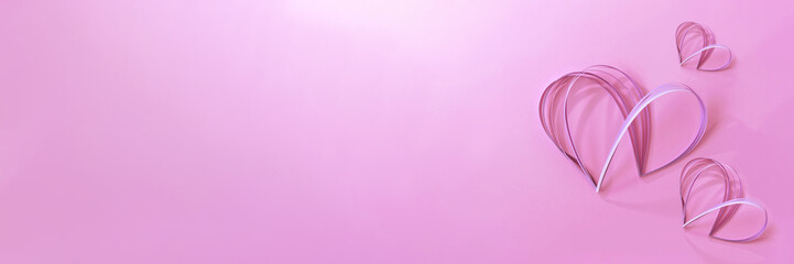 Obraz premium Styled paper crafted quilled hearts on bright pink background with soft light shadows, holiday festive long banner for Valentine day celebration, February 14