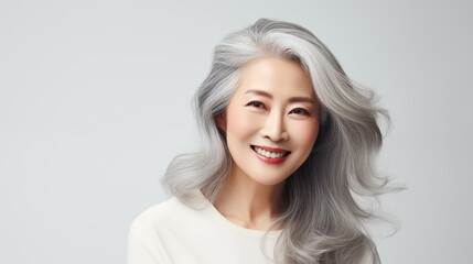 Beautiful senior asian woman with glowing healthy skin close-up. Advertising of cosmetics, perfumes, copy space