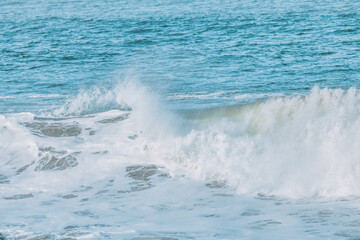 Wave splashing close-up. Crystal clear sea water, in the ocean in San Francisco Bay, blue water, pastel colors.
