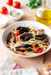 Spaghetti pasta with mussels, tomatoes, garlic and herbs. Healthy eating. Italian food.
