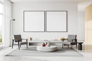 White living room interior with armchairs and posters