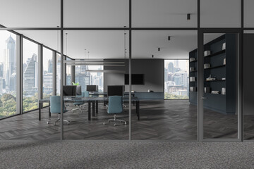 Glass coworking interior with pc monitors on desk, panoramic window