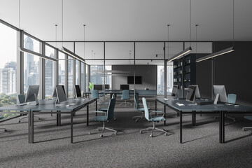 Grey coworking interior with table and pc desktop in row, panoramic window