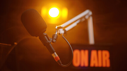 Podcast microphone with spotlight shine on black background