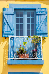 blue and yellow painted wooden window