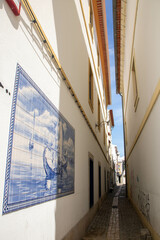 very narrow street in the historic center of Aveiro - 703755361
