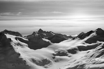 Black and white snowy mountains in evening - 703763356