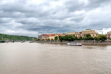 Fototapeta na wymiar Cruise ships on the Vltava River, Rudolfinum, Prague Conservatory, and Czech Bridge