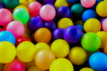 Vibrant Plastic Ball Pit: Close-Up Texture of Multicolored Spheres