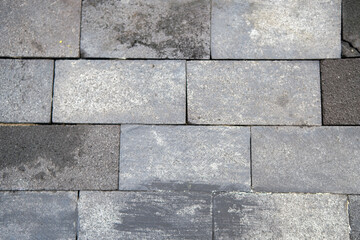 Fototapeta premium Weathered Grey Stone Pavement Texture: Irregular Rectangular Blocks