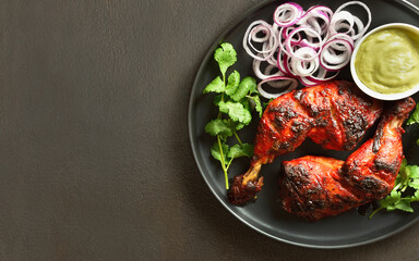 Tandoori chicken served with cilantro and onion