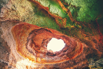 Coastal rocky seascape, hole of Benagil cave in Algarve region in Atlantic ocean, Portugal, Europe