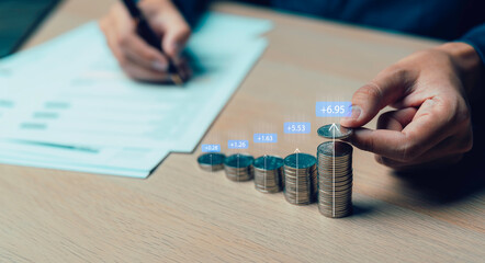businessman putting stack of coins into one row Percent sign for finance, return on investment,...