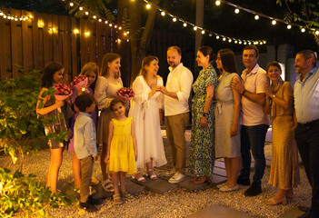Bride, groom, best man, bridesmaids around. Outdoor marriage celebration