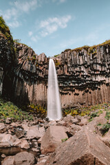 Waterfall in Iceland basalt rocks formation