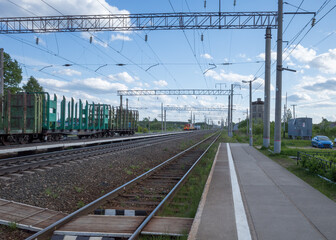 Naklejka premium railway station with empty freight cars for timber logs