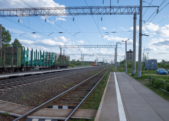 railway station with empty freight cars for timber logs