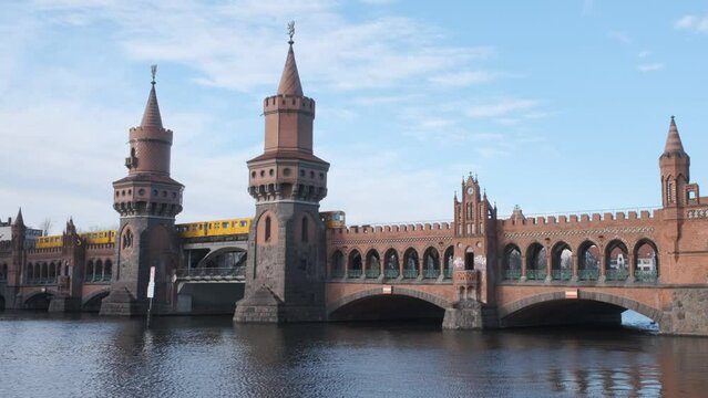 yellow subway train crossing oberbaum Bridge in Berlin, Germany 