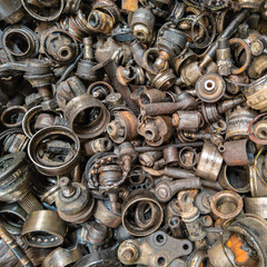 rusted steel scrap pile of used car parts and pieces - full-frame closeup background and texture