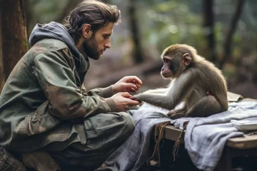 Kussenhoes A male volunteer helps an injured monkey in the wild. The concept of wildlife rescue and conservation © Юлия Падина
