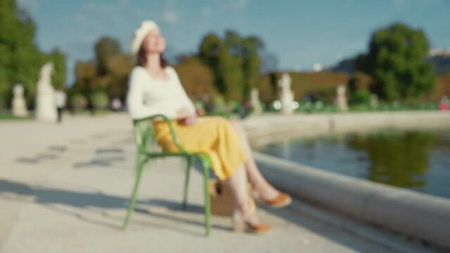 Young girl relaxing in the Tuileries garden in Paris