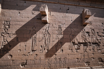 The Temple of Kalabsha (Temple of Mandulis) in Aswan, Egypt is an ancient Egyptian temple that was originally located at Bab al-Kalabsha (Gate of Kalabsha)  50 km south of Aswan. Relief on the walls  - obrazy, fototapety, plakaty