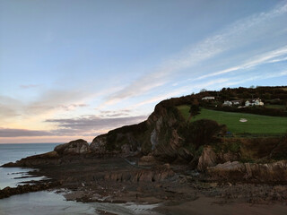 Fototapeta premium Pale sunrise. Combe Martin, North Devon