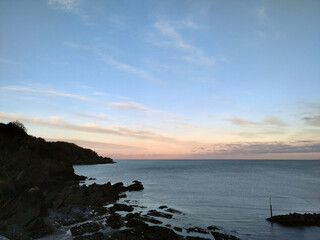 Pale sunrise. Combe Martin, North Devon