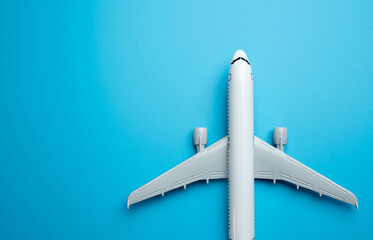 Airliner plane on a blue background and place for text. Traveling by plane. Booking tickets and accumulating air mile bonuses. Commercial flights.