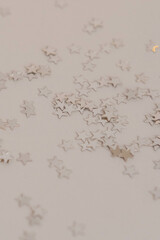 Silver stars confetti on a white background. Festive background