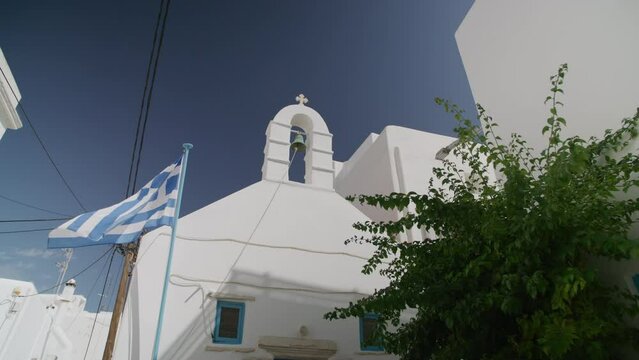 A greek flag and a church bell. Mykonos, Greece
